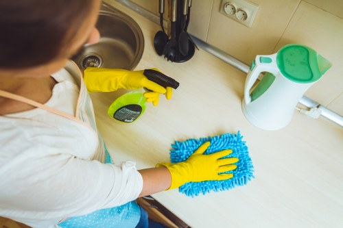 Local cleaner handling linen changeover in a Camden apartment between guest stays